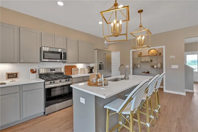 a kitchen with a sink stove and cabinets