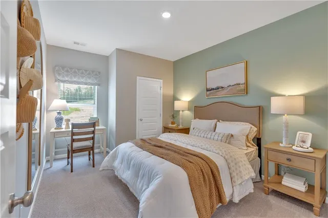 a bedroom with a bed and a lamp on table