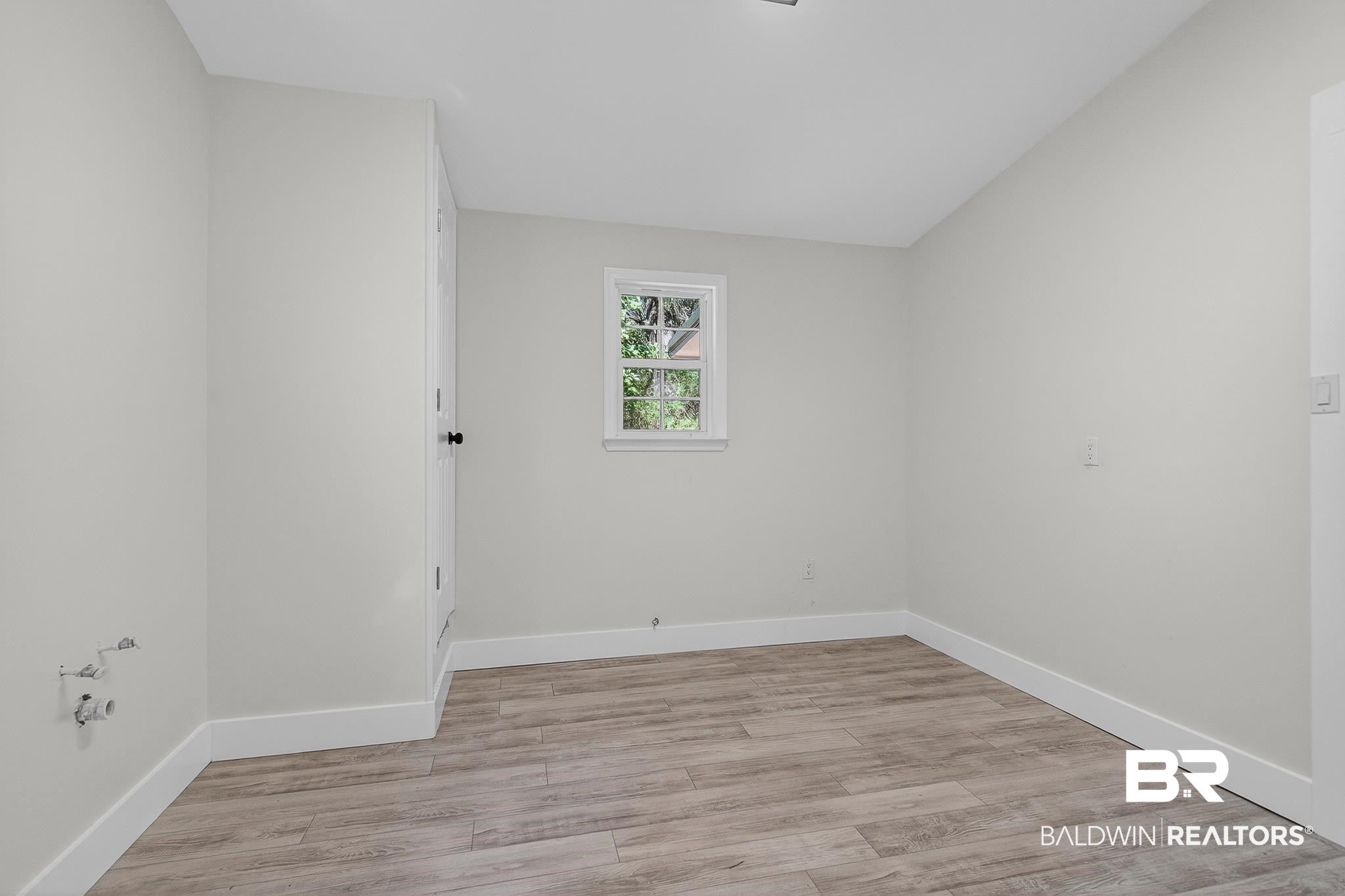 10650 Old Pascagoula Road Theodore, AL 36582 - Photo 56 of 77 Empty room with light wood-type flooring and lofted ceiling