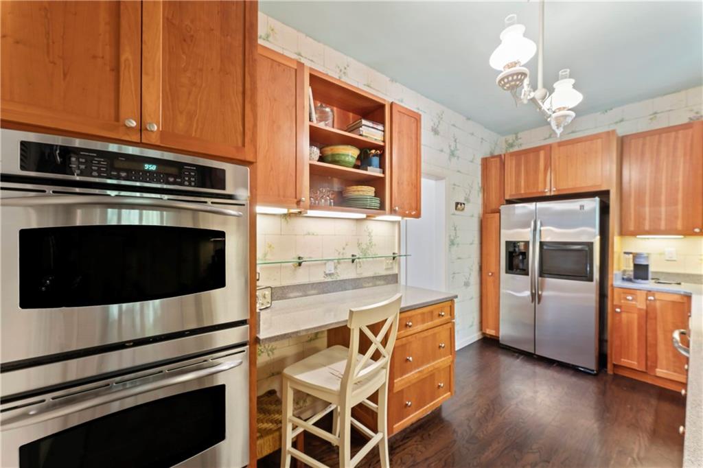 1521 Wightman Street Pittsburgh, PA 15217 - Photo 13 of 40 a kitchen with stainless steel appliances a stove a microwave and a hard wood floors