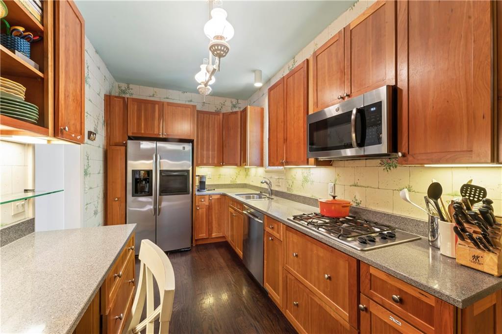 1521 Wightman Street Pittsburgh, PA 15217 - Photo 14 of 40 a kitchen with stainless steel appliances a stove sink microwave and cabinets