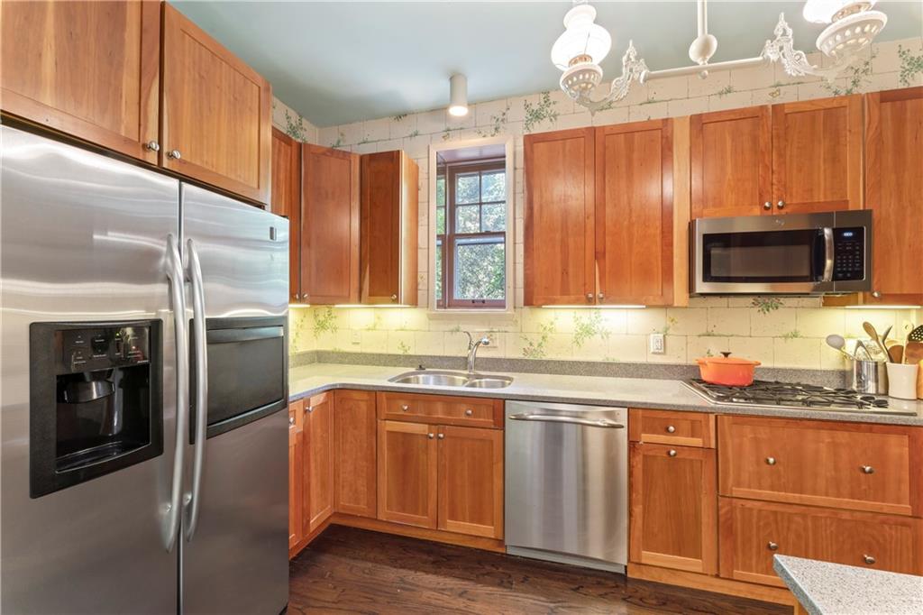 1521 Wightman Street Pittsburgh, PA 15217 - Photo 15 of 40 a kitchen with stainless steel appliances granite countertop a refrigerator a sink a stove and cabinets