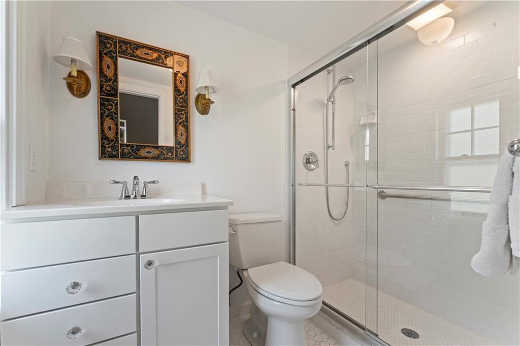 1521 Wightman Street Pittsburgh, PA 15217 - Photo 25 of 40 a bathroom with a sink a toilet and shower