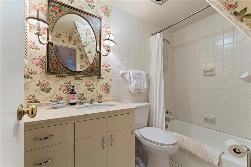 1521 Wightman Street Pittsburgh, PA 15217 - Photo 28 of 40 a bathroom with a sink a mirror a toilet and a shower
