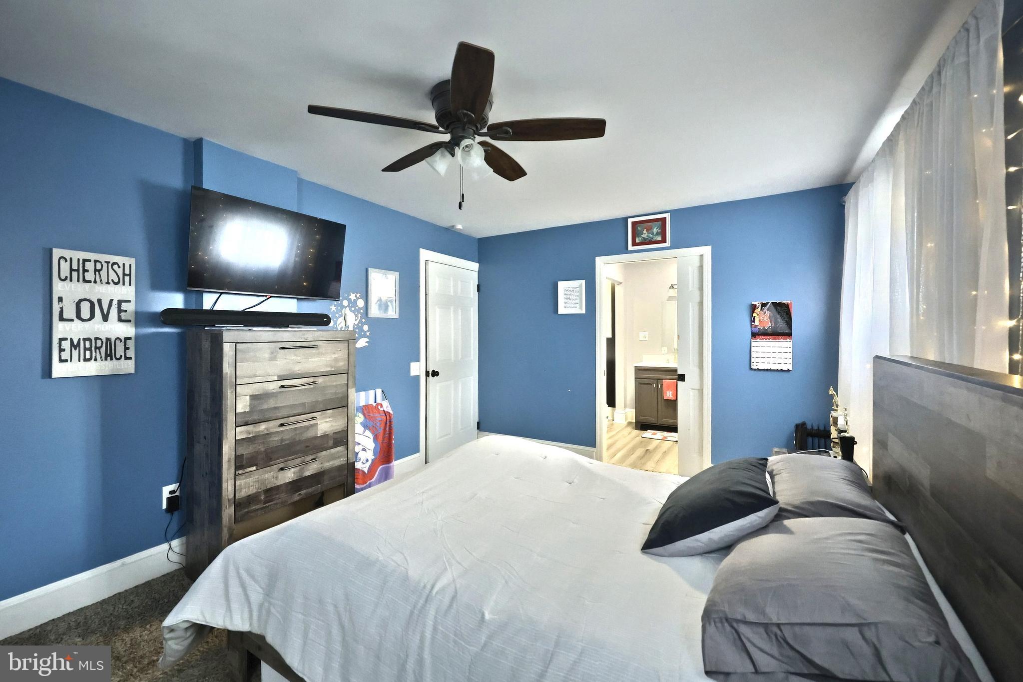 14 Gateway Road York, PA 17403 - Photo 12 of 35 a bedroom with a bed and a flat tv screen on dresser