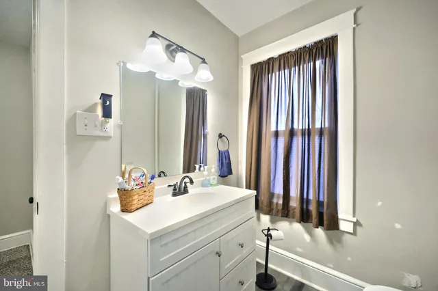a bathroom with a shower curtain and a window