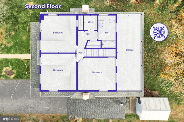 a street sign on a wall next to a road