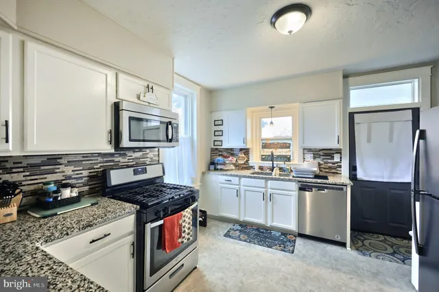 a living room with furniture a ceiling fan and a window