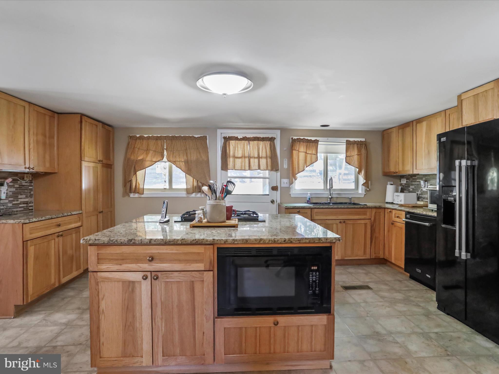 97 Devonshire Road Hedgesville, WV 25427 - Photo 8 of 44 a kitchen with stainless steel appliances granite countertop a stove a sink dishwasher and a refrigerator