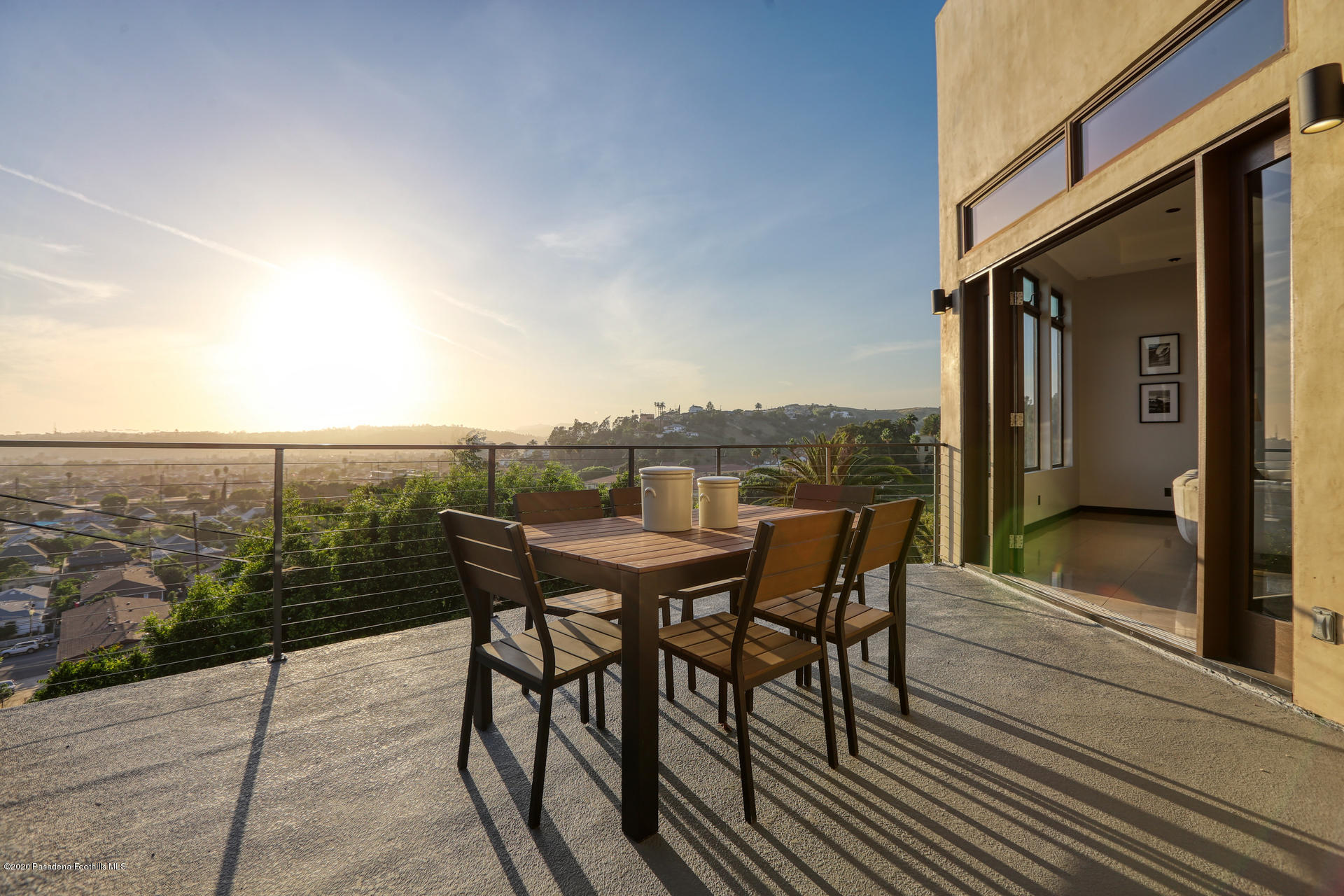 2315 Holgate Square Los Angeles, CA 90031 - Photo 20 of 56 a view of a balcony with table and chairs and wooden floor