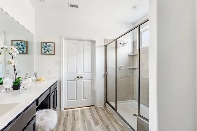 a hallway with sink and wooden floor