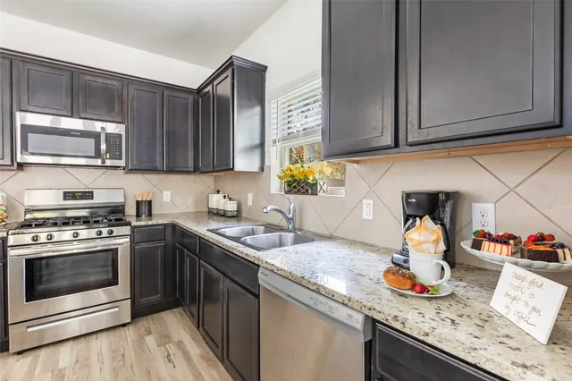 a kitchen with a stove and a microwave oven