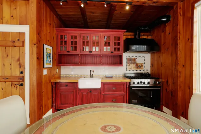 a kitchen with stainless steel appliances granite countertop a stove top oven a sink dishwasher and a microwave oven with cabinets