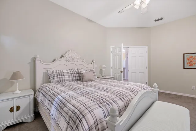 a bedroom with a bed and a lamp