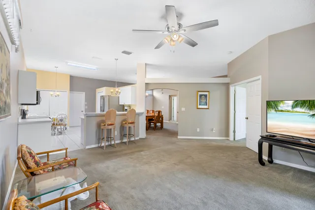 a view of a livingroom with furniture and a flat screen tv