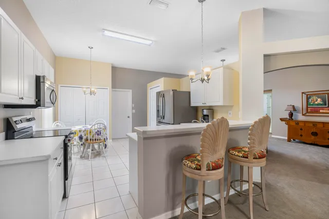 a living room with furniture and kitchen view