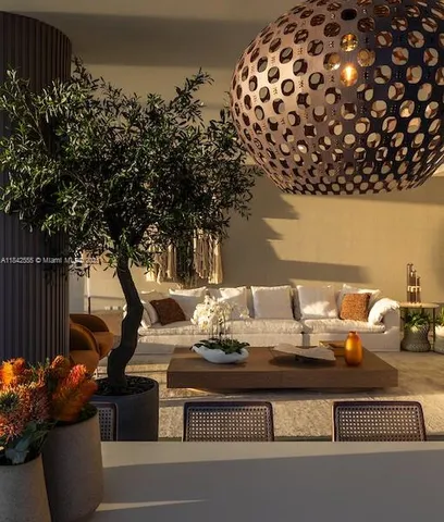 a view of a patio with table and chairs and a potted plant