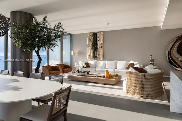 a living room with furniture and a potted plant