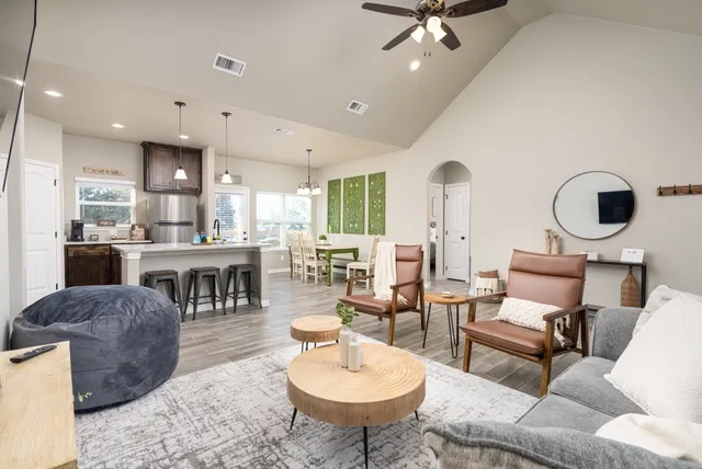a living room with furniture a rug and white walls