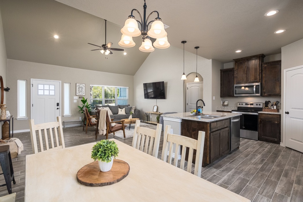 117 Lightning Bolt Spring Branch, TX 78070 - Photo 4 of 12 a kitchen with a table chairs stove and microwave