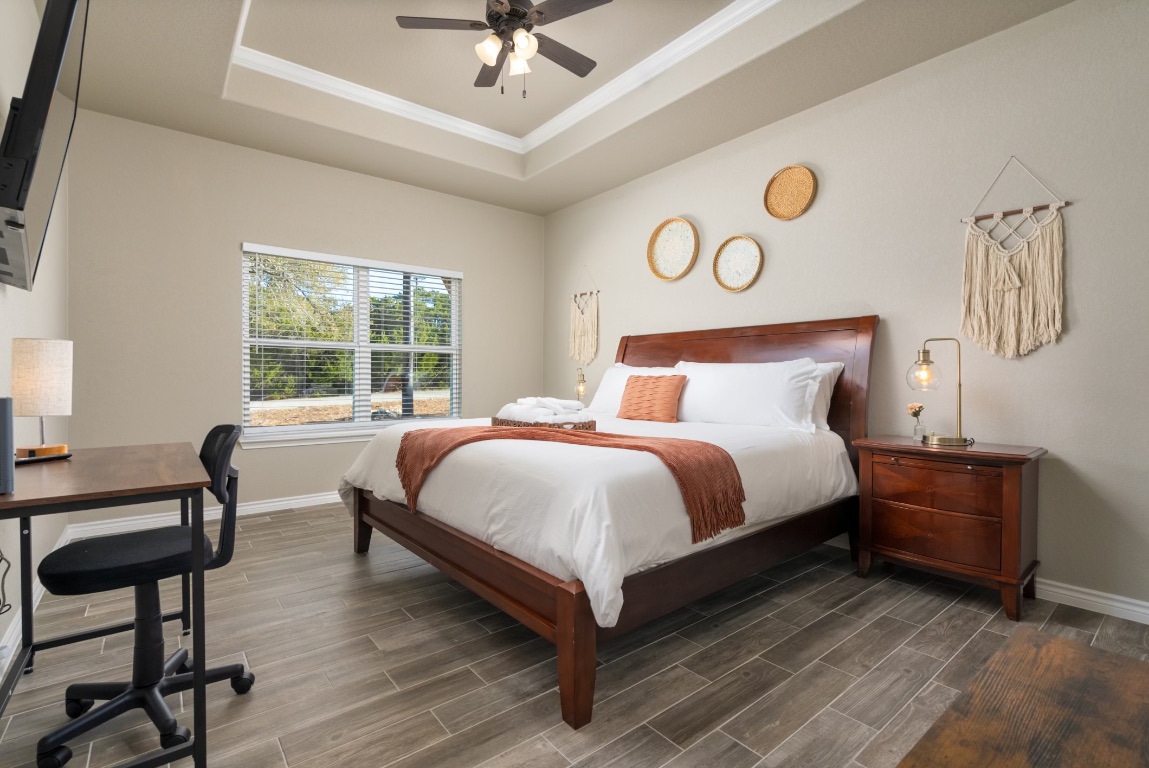 117 Lightning Bolt Spring Branch, TX 78070 - Photo 7 of 12 a bedroom with a bed and a chandelier