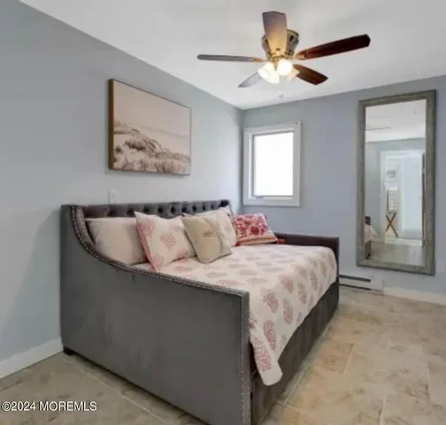 a spacious bedroom with a bed and a chandelier