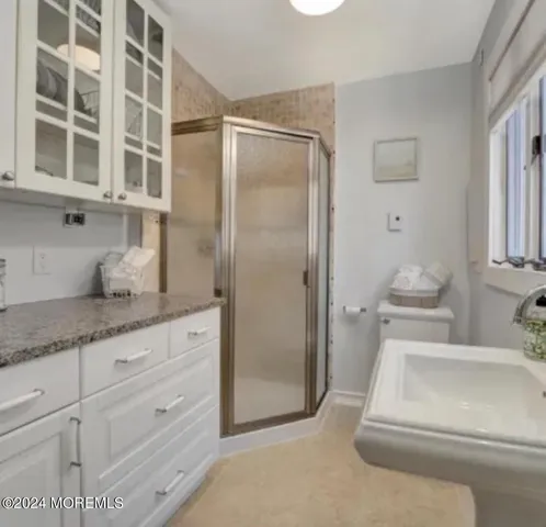 a bathroom with a granite countertop sink mirror and vanity