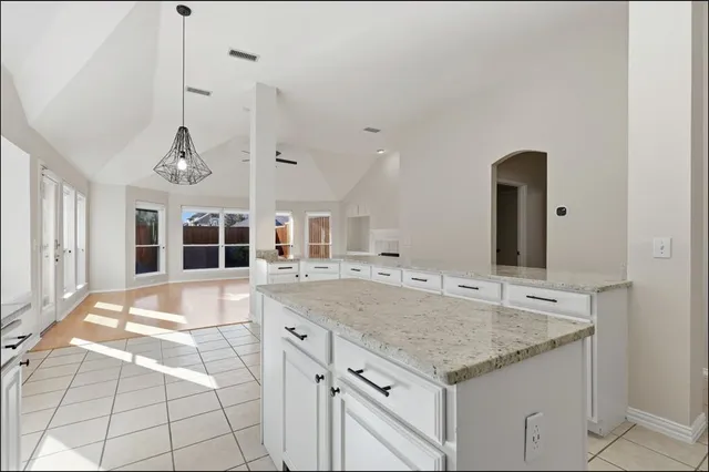 a view of a kitchen with granite countertop a sink and a stove