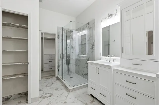 a bathroom with a shower sink and mirror