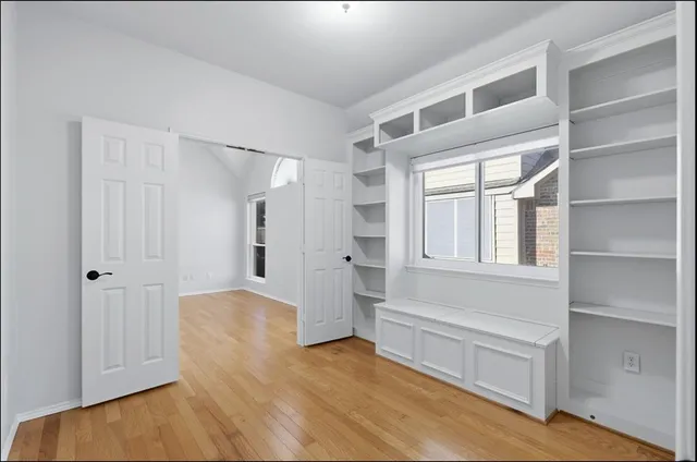 a view of walk in closet with empty racks