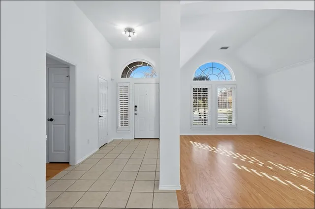 a view of empty room with window and fireplace