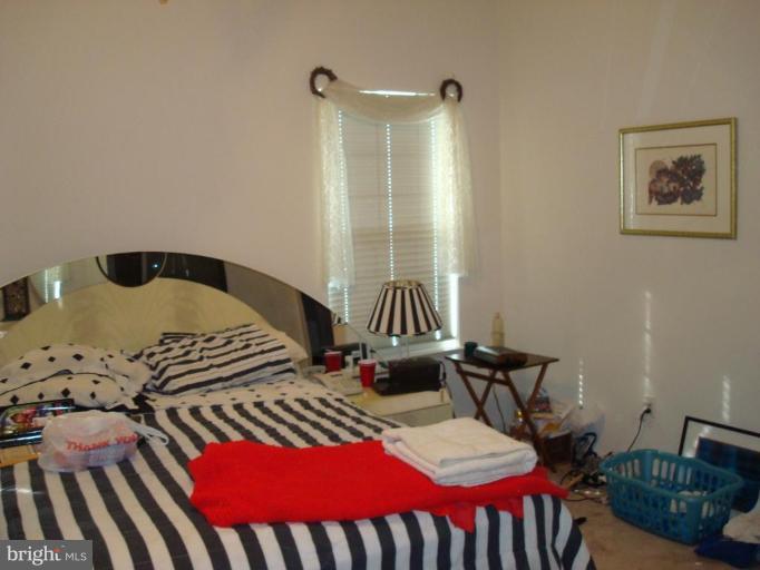 6149 Good Hunters Ride Columbia, MD 21045 - Photo 11 of 30 a bedroom with a bed and wooden floor