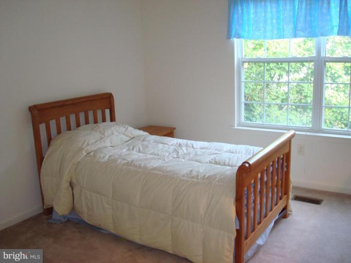 6149 Good Hunters Ride Columbia, MD 21045 - Photo 17 of 30 a bedroom with a bed and a window