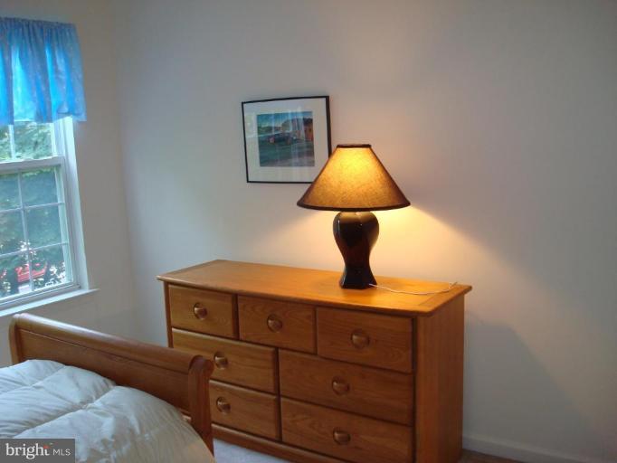 6149 Good Hunters Ride Columbia, MD 21045 - Photo 18 of 30 a bed room with a bed and a lamp