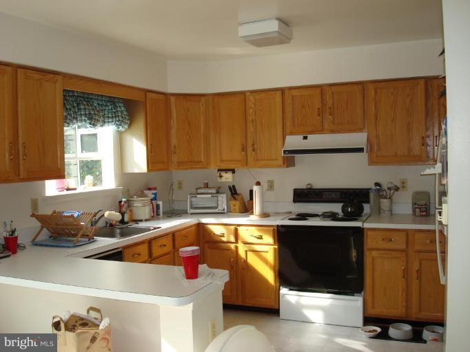 6149 Good Hunters Ride Columbia, MD 21045 - Photo 7 of 30 a kitchen with a sink stove top oven and cabinets
