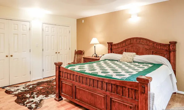 a bedroom with a bed and a lamp with window