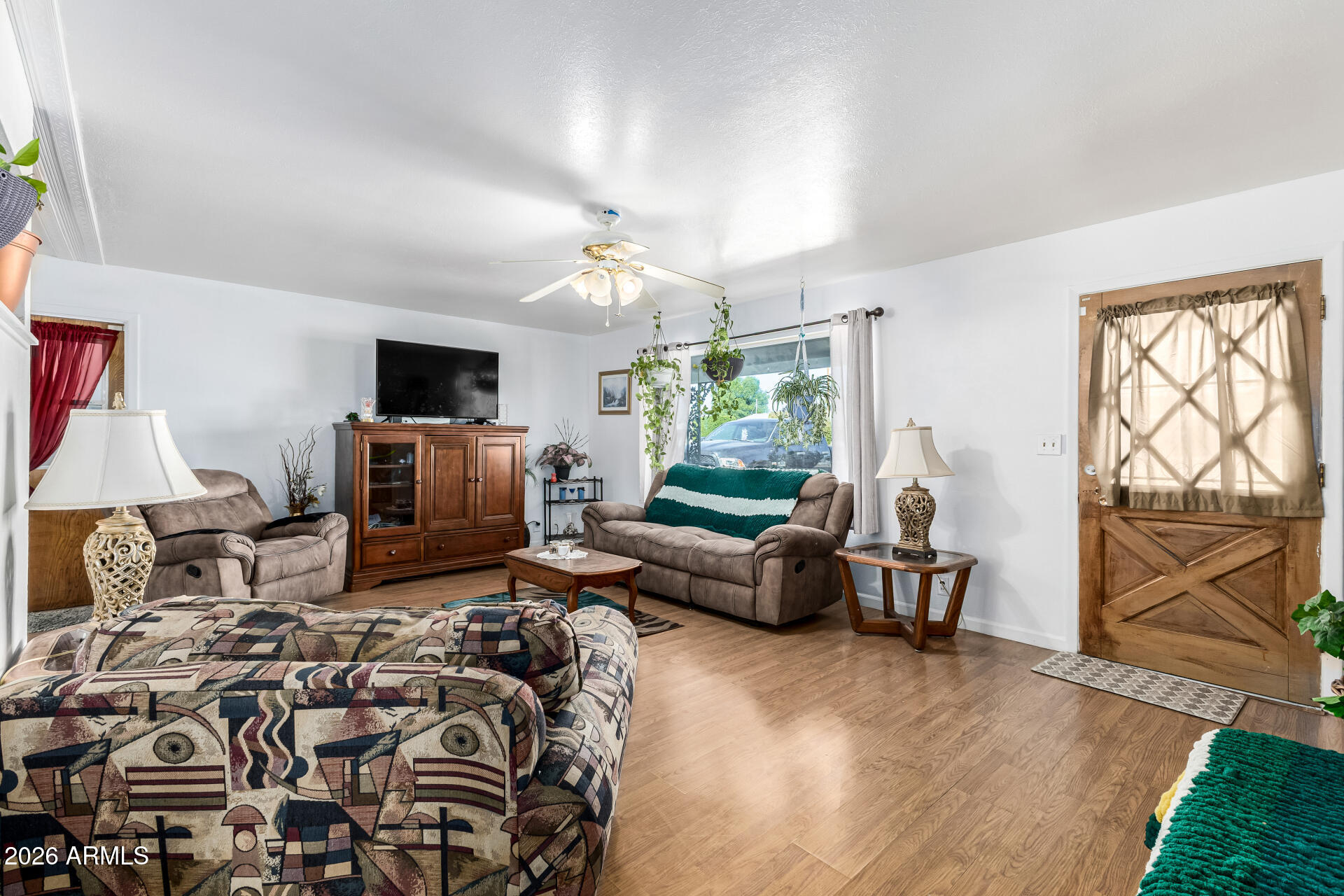 5519 Casper Road Mesa, AZ 85205 - Photo 4 of 23 a living room with furniture a flat screen tv and a fireplace