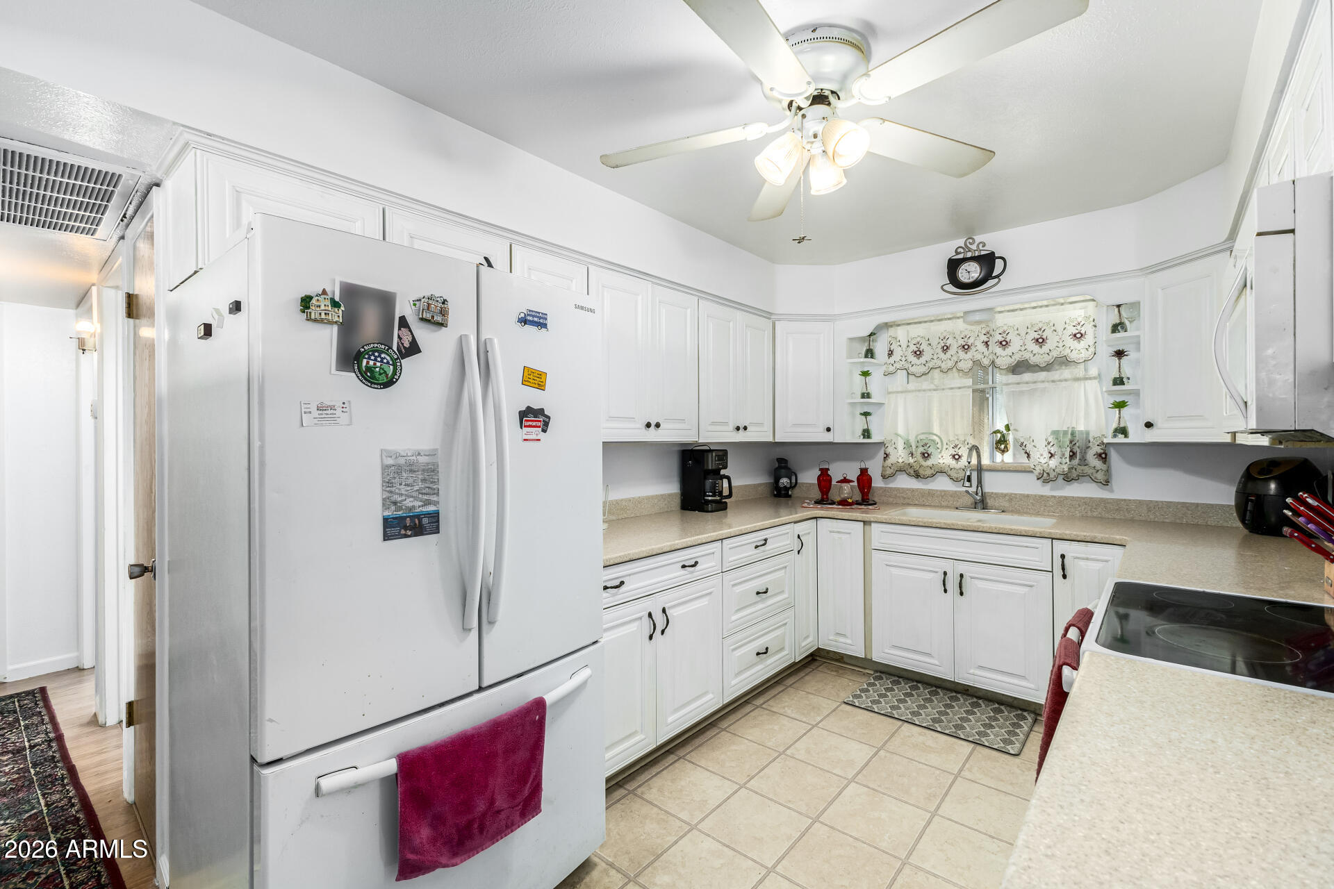 5519 Casper Road Mesa, AZ 85205 - Photo 8 of 23 a kitchen with granite countertop a white refrigerator stove and white cabinets