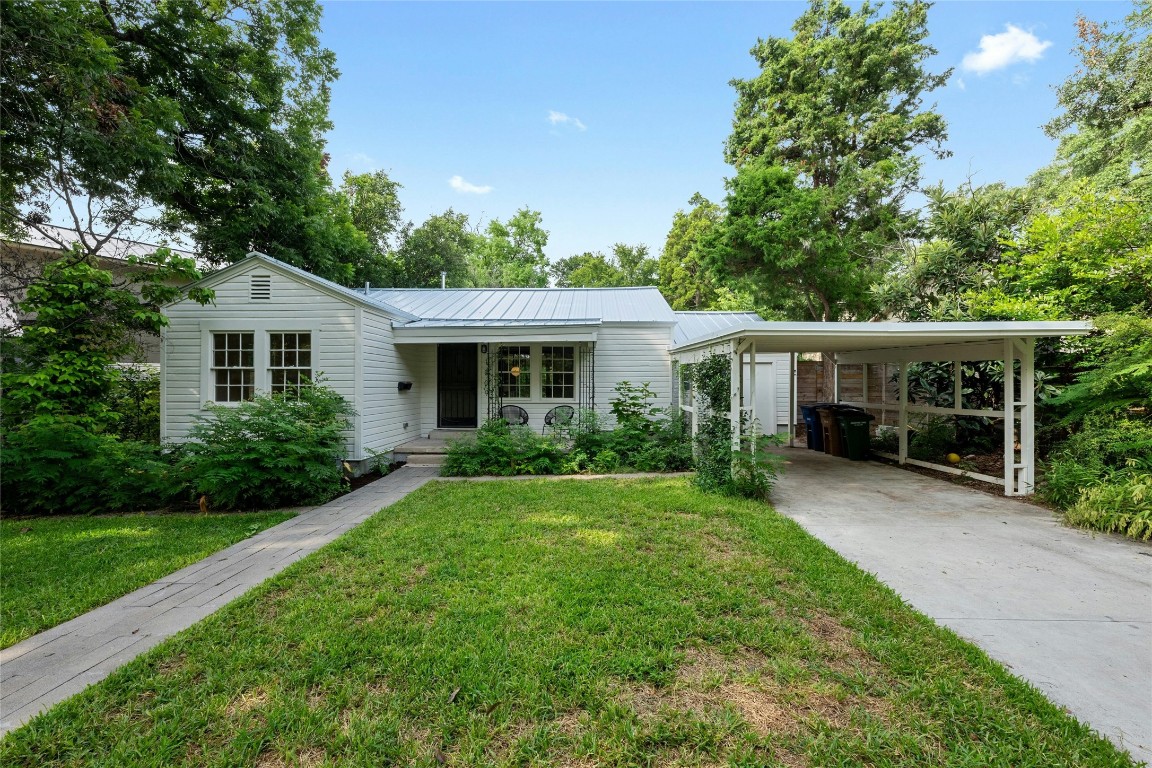 a front view of a house with a yard and porch