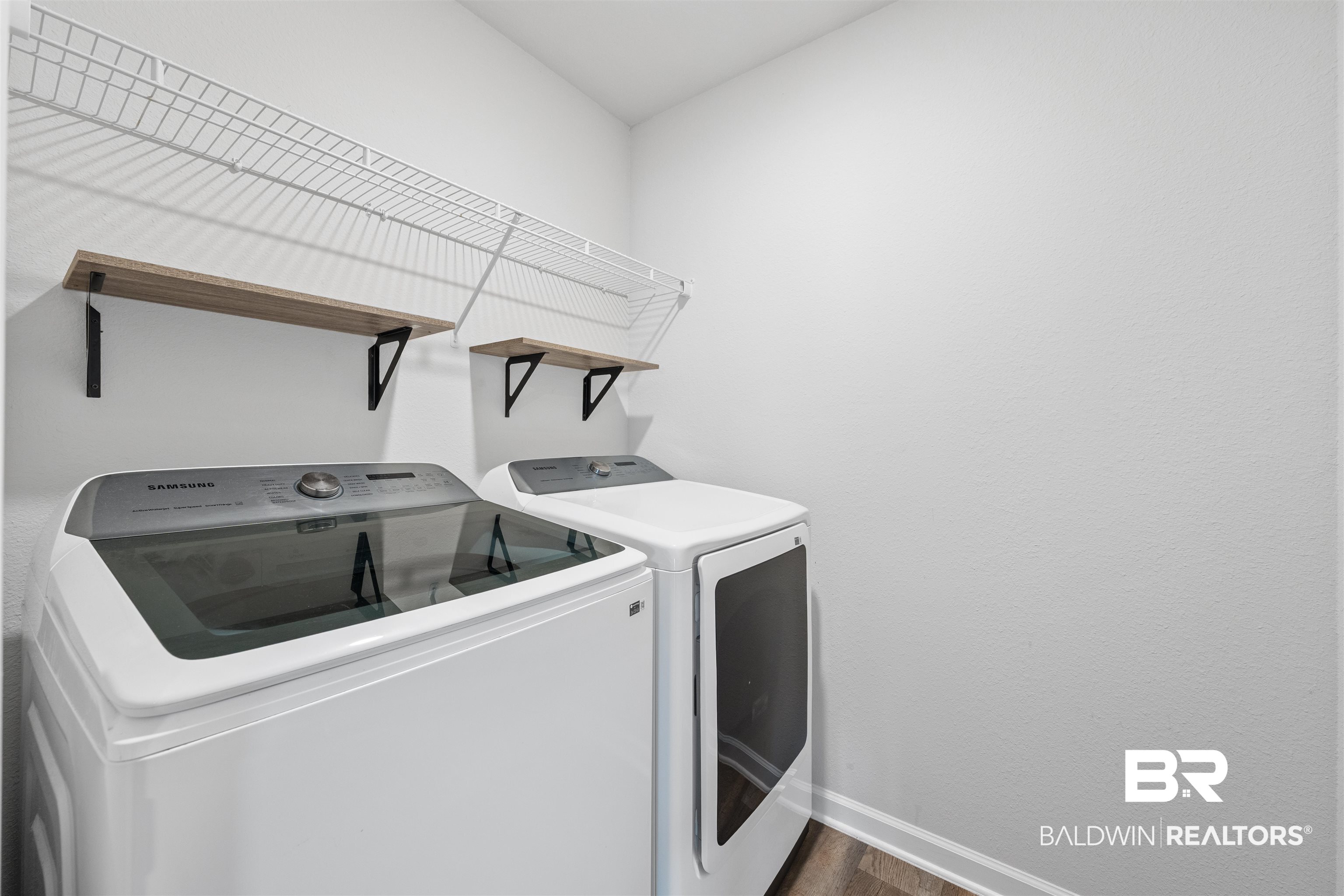 7457 Brompton Drive Foley, AL 36535 - Photo 23 of 24 Laundry area with washing machine and clothes dryer and baseboards