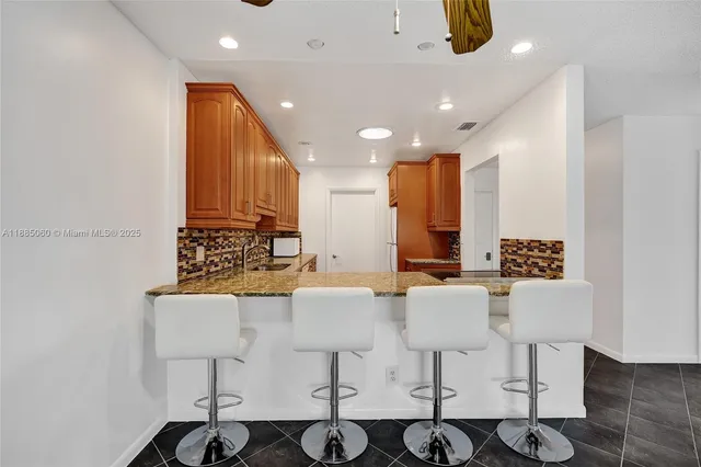 a large kitchen with a table and chairs