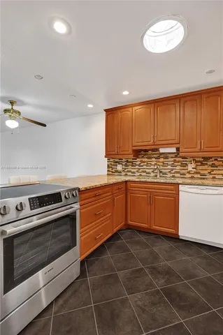 a kitchen with a stove a sink and a refrigerator