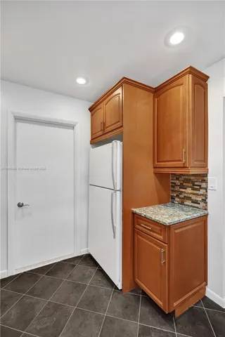 a view of kitchen with cabinets