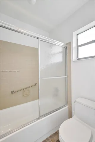 a bathroom with a toilet and a bathtub