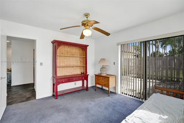 a bedroom with furniture window and a ceiling fan