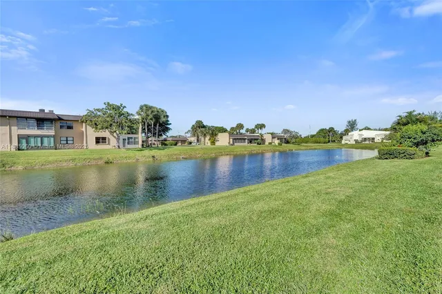 a view of a lake with houses in the back