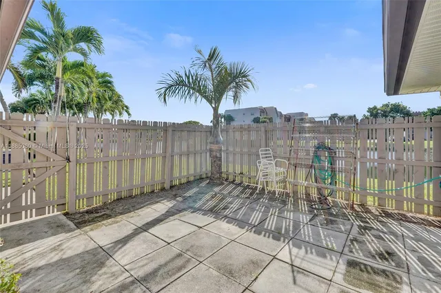 a view of a backyard with a iron fence