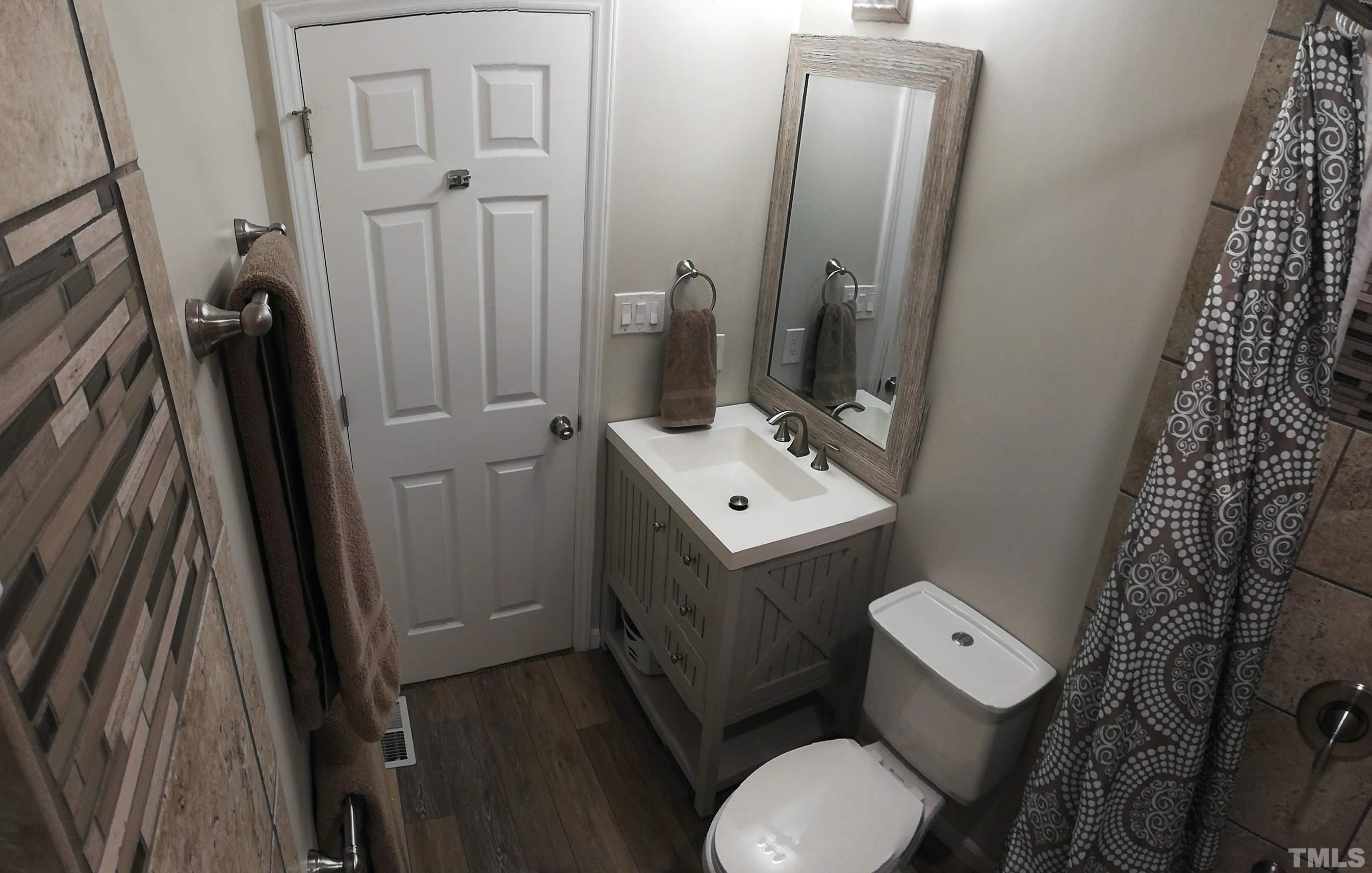 3 Prestwick Place Durham, NC 27705 - Photo 10 of 21 a bathroom with sink toilet and mirror