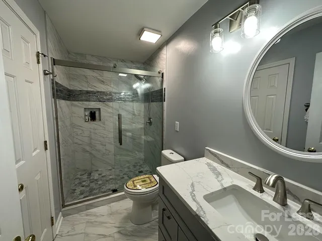 a bathroom with a sink toilet and shower
