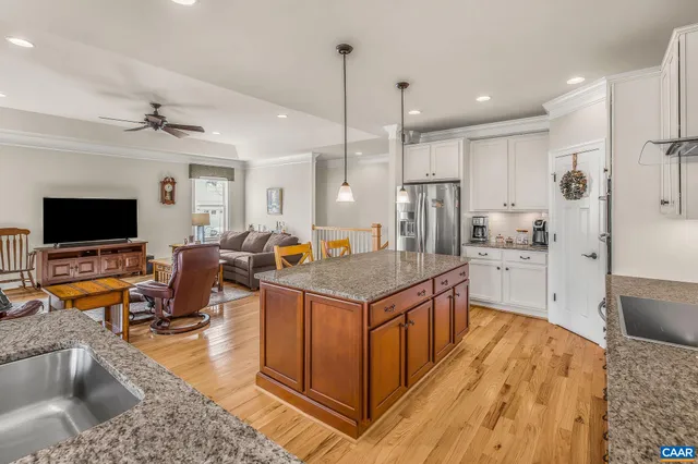 a living room with furniture and a ceiling fan